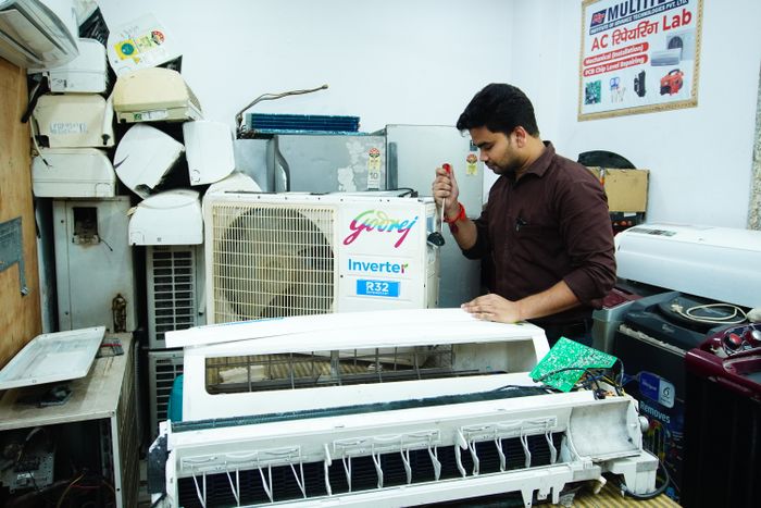 Technician repairing an air conditioner